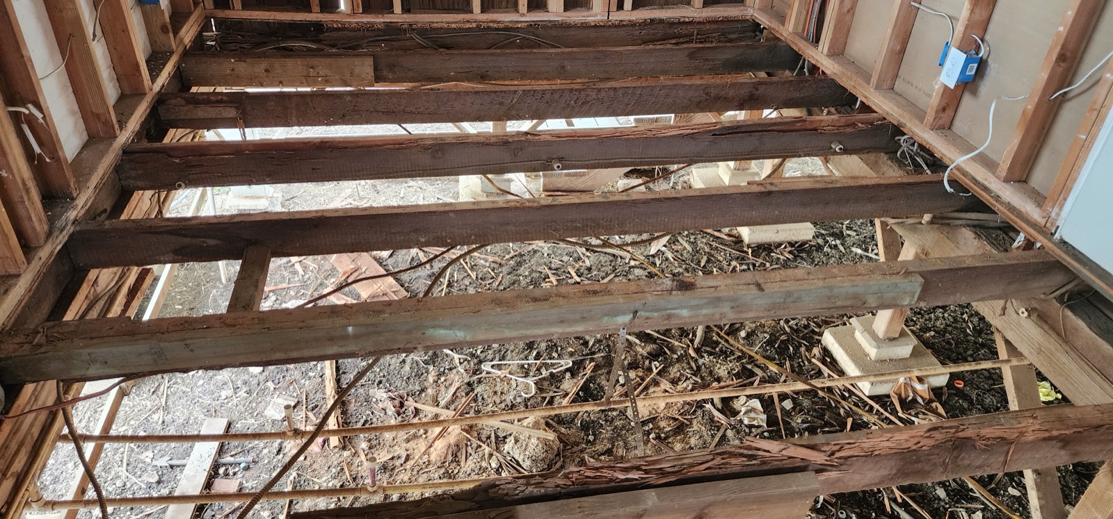 Demolished floor joists exposed during Unit D renovation